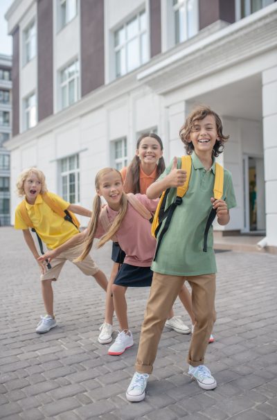 Playing. Schoolchildren playing in school yard and feeling happy